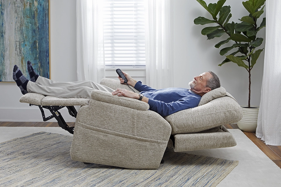 Man lying flat in a recliner