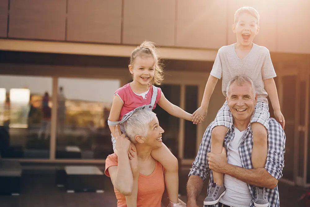 Grandparents smiling with her two kids