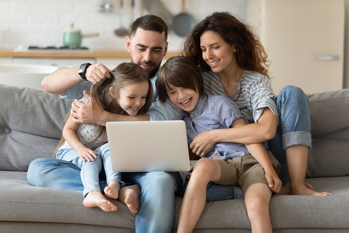 Family of four getting excited about picking out their new furniture after measuring their living space. 